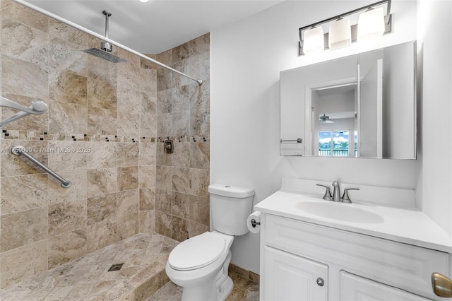 full bath with vanity, toilet, and tiled shower