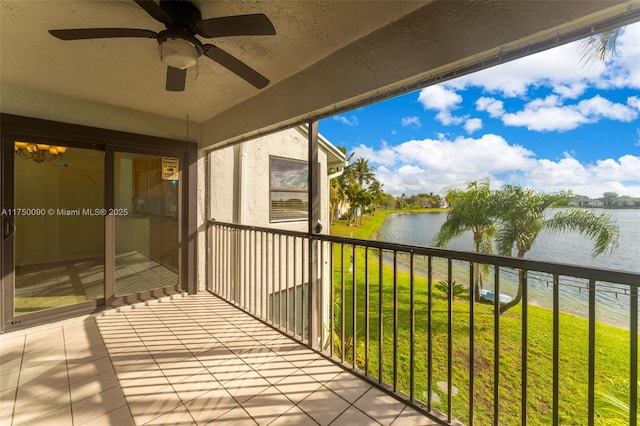 balcony featuring a water view and ceiling fan