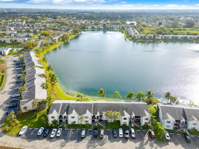 drone / aerial view with a water view and a residential view