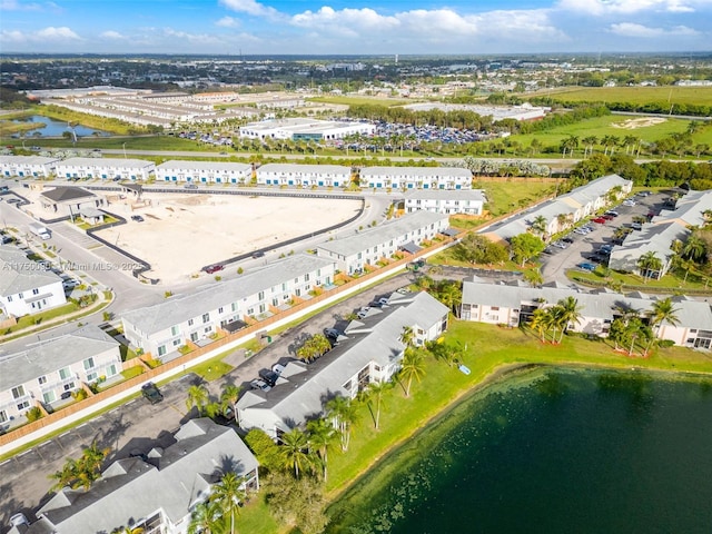 drone / aerial view featuring a water view and a residential view