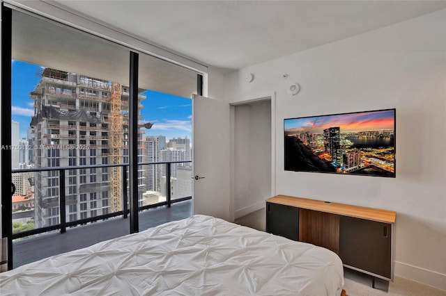 bedroom featuring baseboards and floor to ceiling windows