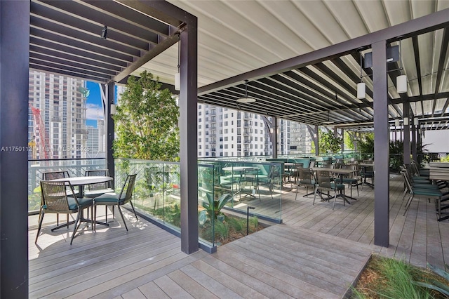 wooden terrace featuring a view of city and outdoor dining area