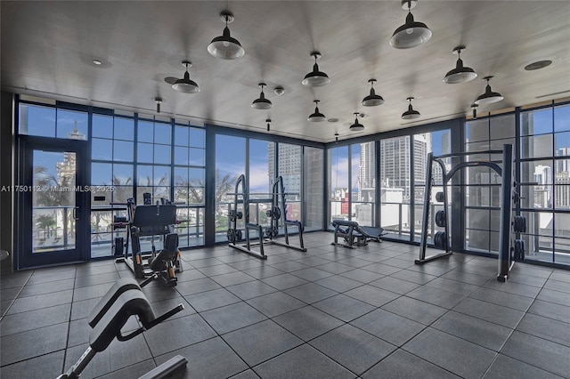 gym featuring floor to ceiling windows and a city view