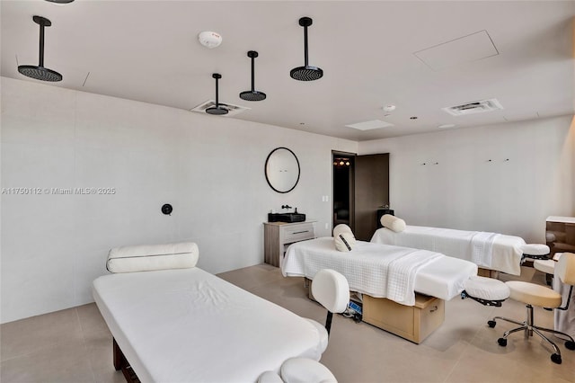 bedroom featuring light tile patterned floors and visible vents