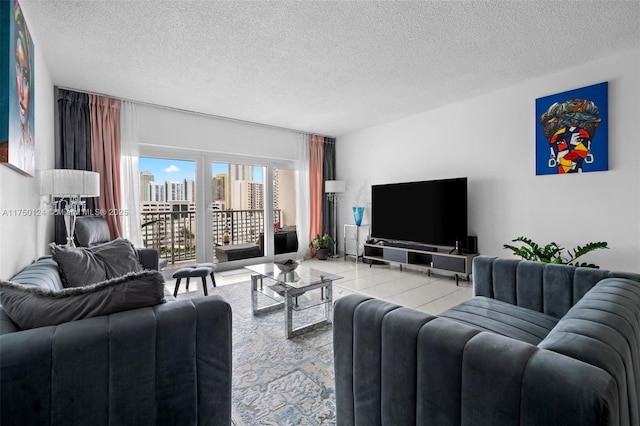 living area featuring light tile patterned floors and a textured ceiling