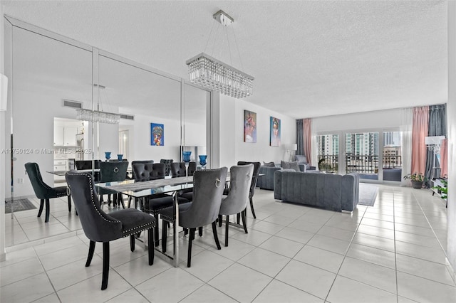 300 Bayview Dr Unit 807, Sunny Isles Beach, FL 33160 - dining area with a chandelier, a textured ceiling, and light tile patterned floors
