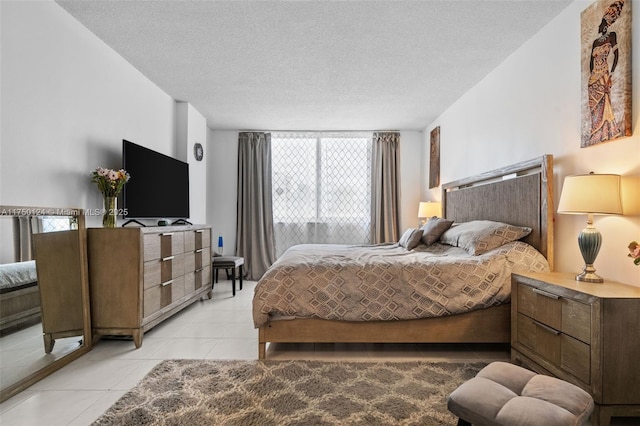 bedroom with light tile patterned flooring and a textured ceiling