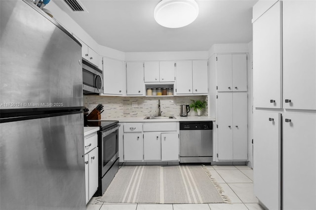 300 Bayview Dr Unit 807, Sunny Isles Beach, FL 33160 - kitchen featuring appliances with stainless steel finishes, a sink, decorative backsplash, and light countertops