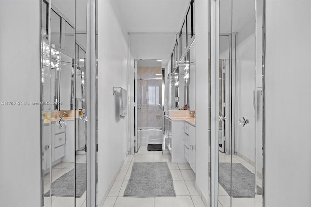 full bathroom featuring tile patterned flooring, a stall shower, and vanity