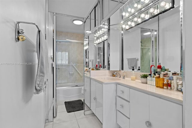 bathroom featuring tile patterned flooring, vanity, and bath / shower combo with glass door