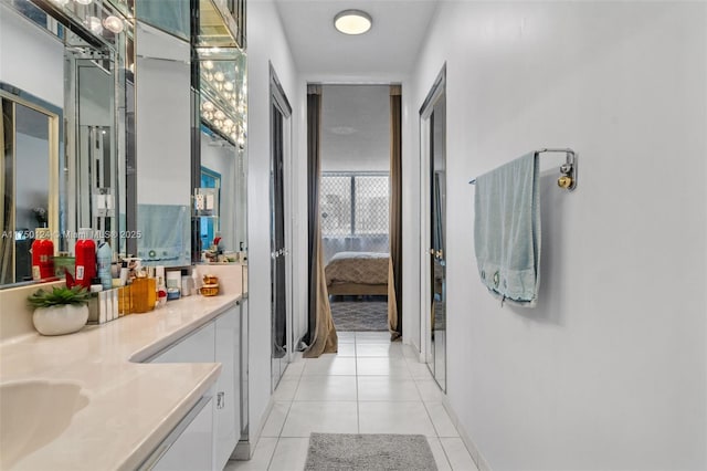 full bathroom featuring vanity, ensuite bath, and tile patterned floors