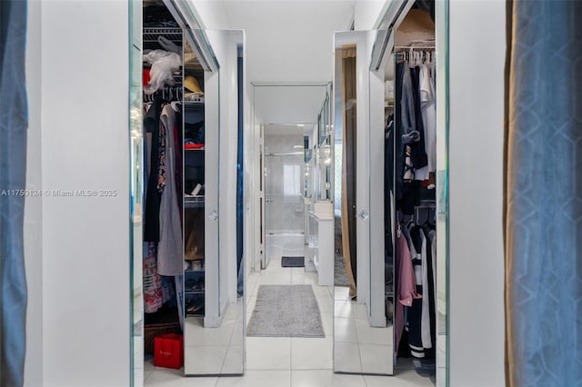 walk in closet with tile patterned floors