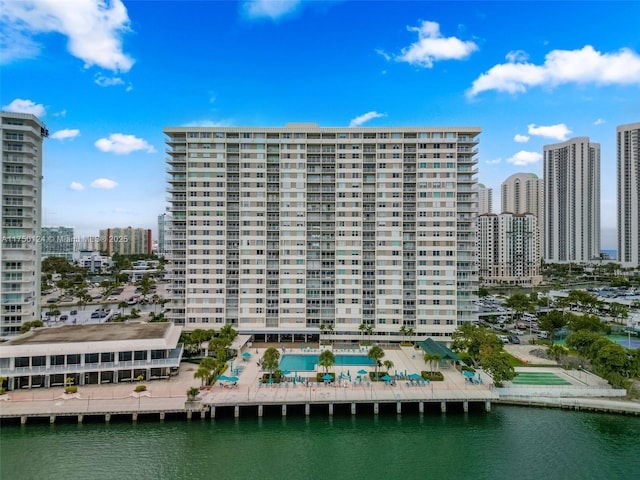 view of building exterior featuring a view of city and a water view