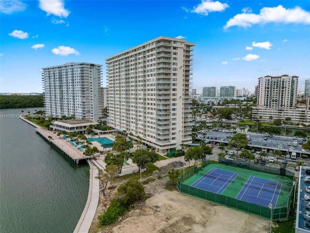 birds eye view of property with a city view and a water view