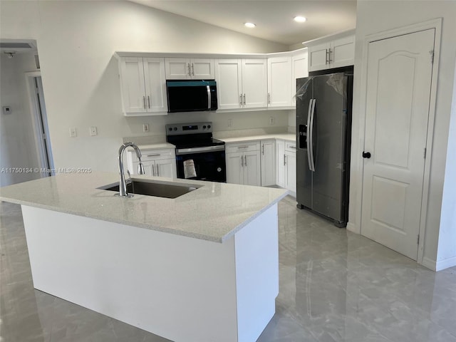 kitchen with light stone counters, lofted ceiling, appliances with stainless steel finishes, white cabinets, and a sink