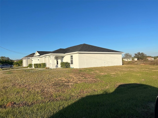 view of property exterior with a lawn and stucco siding