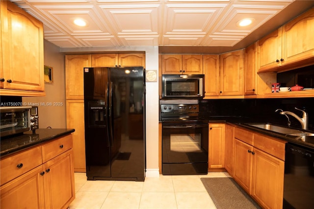 kitchen with black appliances, an ornate ceiling, light tile patterned floors, and a sink