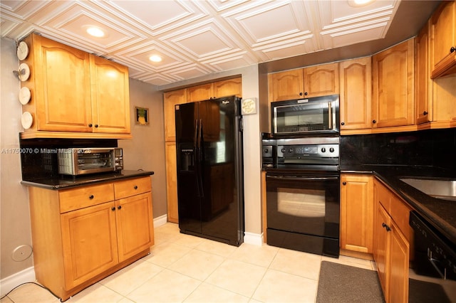 kitchen with an ornate ceiling, recessed lighting, brown cabinetry, black appliances, and baseboards