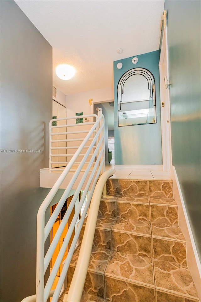 stairs featuring visible vents and baseboards