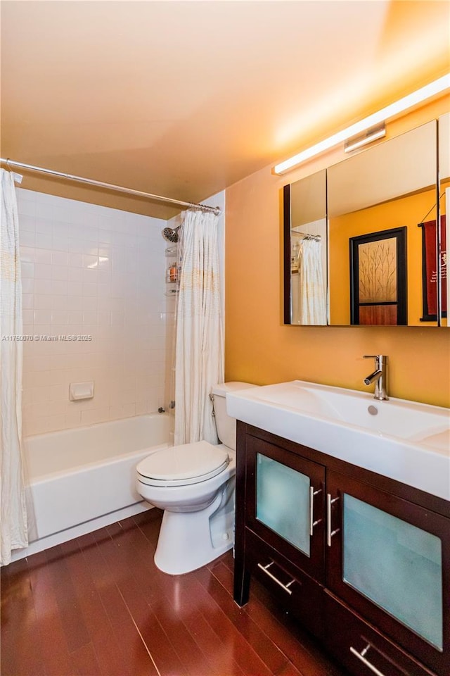 full bathroom with vanity, wood finished floors, toilet, and shower / bathtub combination with curtain