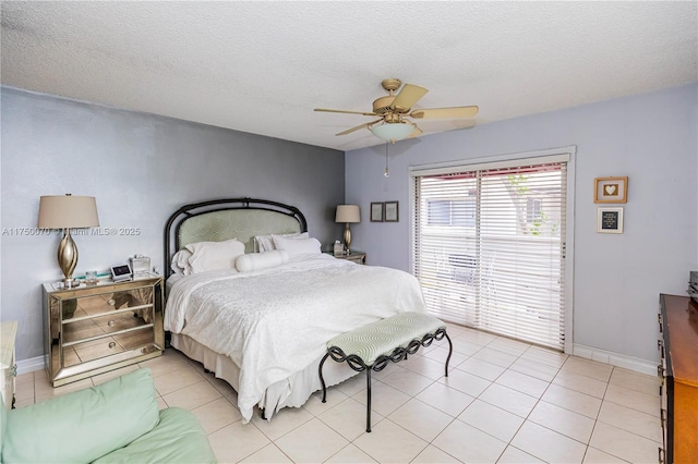 bedroom with a textured ceiling, ceiling fan, light tile patterned flooring, and baseboards