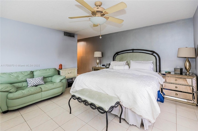 bedroom with light tile patterned floors, ceiling fan, and visible vents