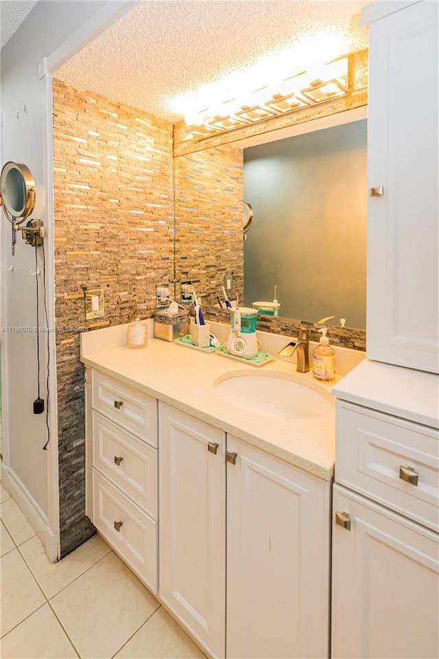 bathroom featuring a textured ceiling, vanity, and tile patterned floors