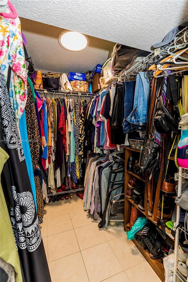 spacious closet featuring light tile patterned flooring