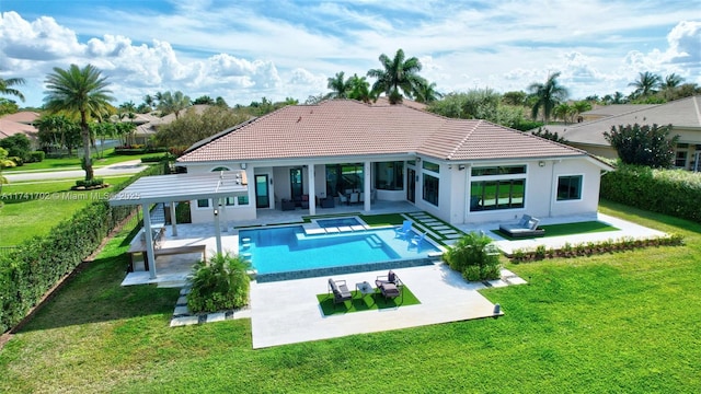 rear view of property with fence, a yard, an outdoor pool, a patio area, and a hot tub