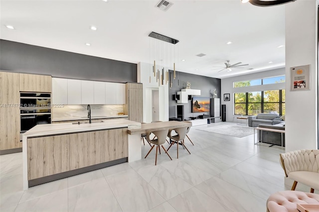 14955 SW 33rd St, Davie, FL 33331 - kitchen featuring modern cabinets, open floor plan, a ceiling fan, light brown cabinets, and light countertops