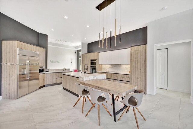 14955 SW 33rd St, Davie, FL 33331 - kitchen with stainless steel appliances, modern cabinets, a towering ceiling, light countertops, and light brown cabinetry