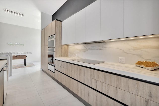 14955 SW 33rd St, Davie, FL 33331 - kitchen with light brown cabinets, black electric stovetop, light countertops, decorative backsplash, and modern cabinets