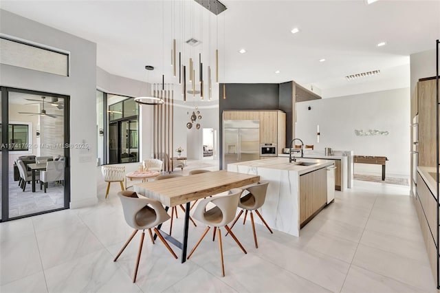 14955 SW 33rd St, Davie, FL 33331 - kitchen featuring stainless steel appliances, modern cabinets, a kitchen island with sink, a ceiling fan, and light countertops