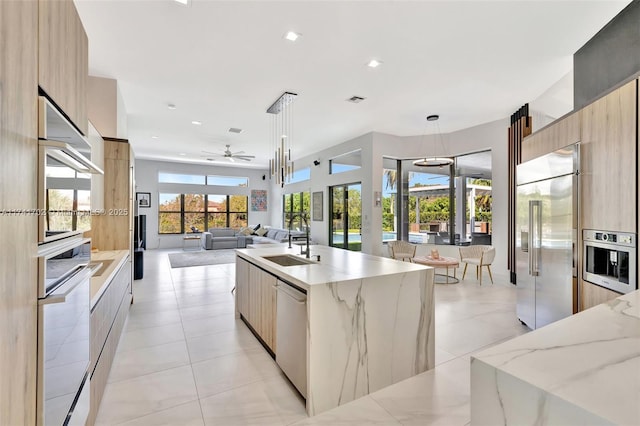 14955 SW 33rd St, Davie, FL 33331 - kitchen featuring modern cabinets, stainless steel appliances, ceiling fan, decorative light fixtures, and light stone countertops