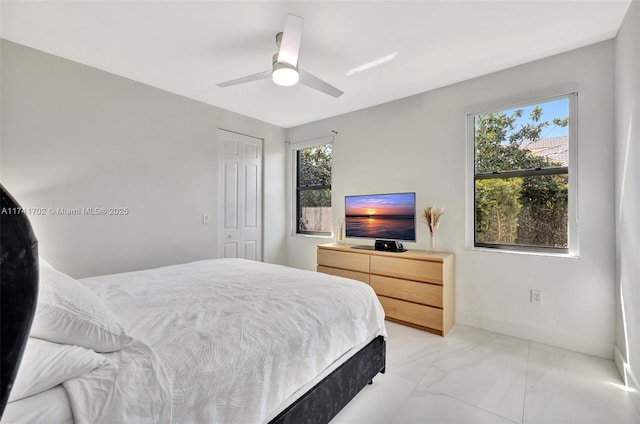 14955 SW 33rd St, Davie, FL 33331 - bedroom featuring light marble finish floors, a closet, and ceiling fan