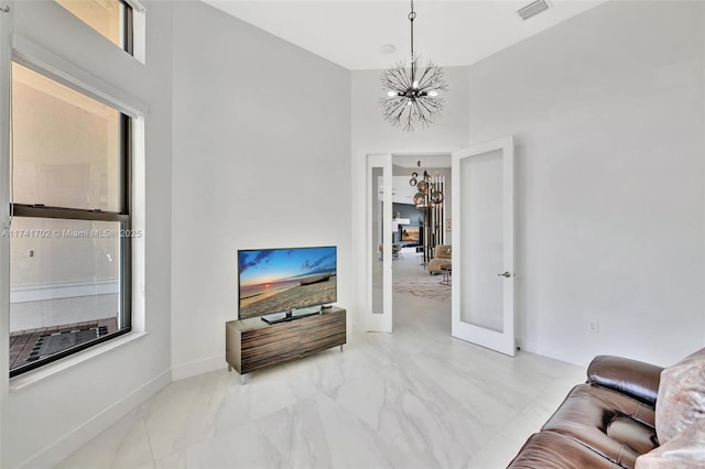 14955 SW 33rd St, Davie, FL 33331 - living area with a chandelier, marble look tile flooring, a high ceiling, and french doors