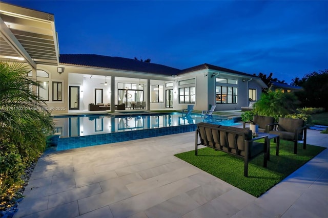 14955 SW 33rd St, Davie, FL 33331 - pool at night featuring outdoor lounge area, a patio, an infinity pool, and a ceiling fan