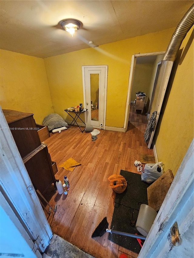 interior space featuring lofted ceiling and wood finished floors