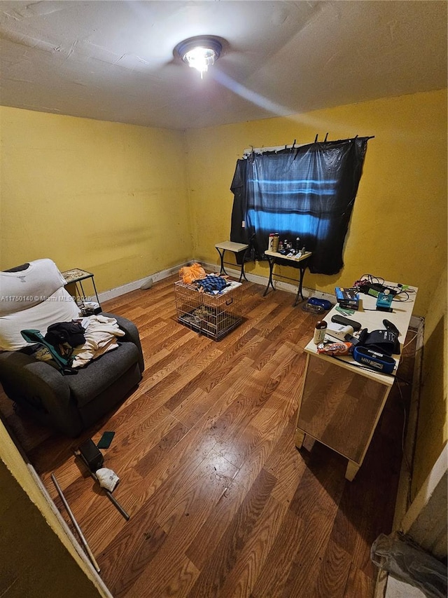 living room featuring wood finished floors and baseboards