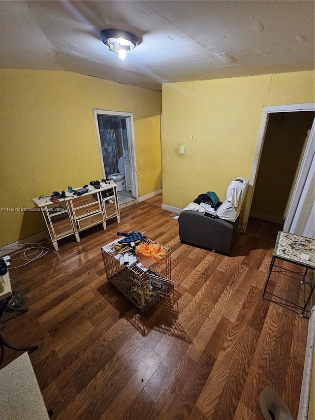 living area featuring wood finished floors and baseboards