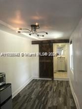 interior space featuring dark wood-style floors and baseboards