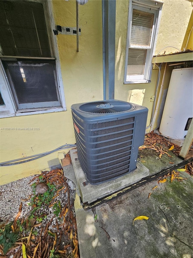 exterior details featuring stucco siding and central AC unit