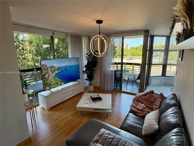 living room with wood finished floors and a chandelier