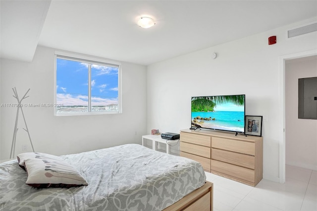 bedroom featuring light tile patterned floors, electric panel, and visible vents