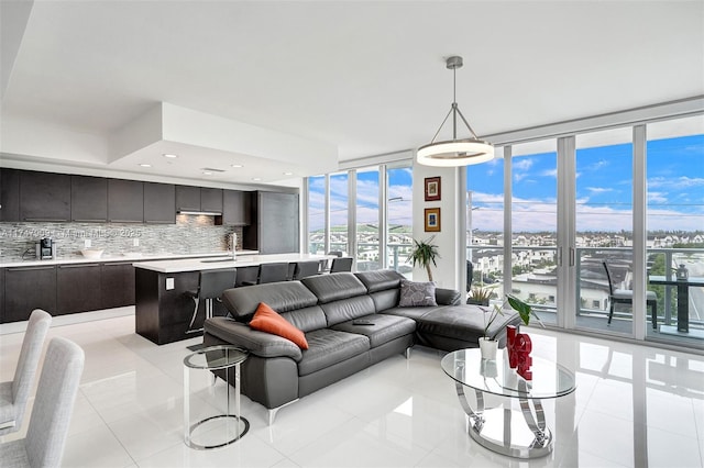 living room featuring light tile patterned floors, expansive windows, and recessed lighting