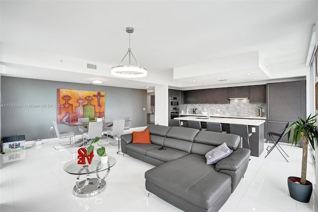 living room with light tile patterned flooring, recessed lighting, visible vents, and baseboards