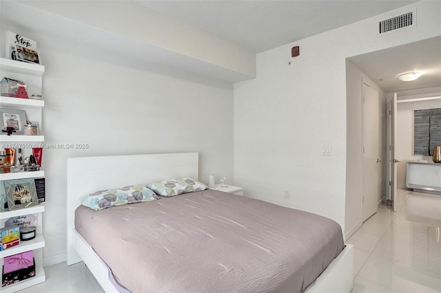 bedroom featuring light tile patterned floors and visible vents