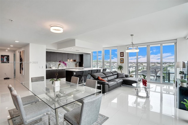 dining space featuring floor to ceiling windows, light tile patterned flooring, recessed lighting, and a wealth of natural light