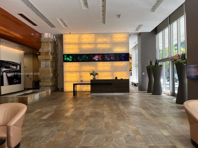 reception area featuring visible vents and ornate columns
