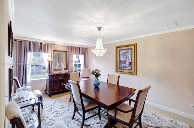 dining space with crown molding, baseboards, visible vents, and a notable chandelier